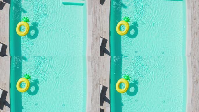漂浮在游泳池水面上的黄色充气环的4k静态镜头