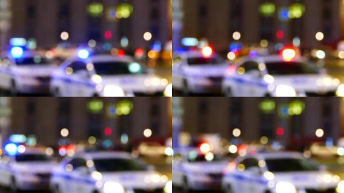 夜间闪烁的警车模糊，城市街道上的交通巡逻