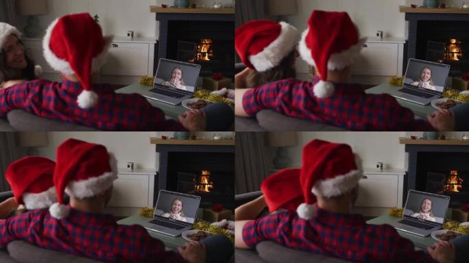 在圣诞节期间与女性朋友进行视频通话的高加索夫妇
