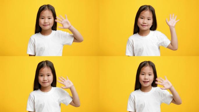 韩国小女孩在黄色背景上挥手示意你好