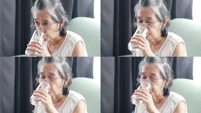 老年妇女在客厅喝水