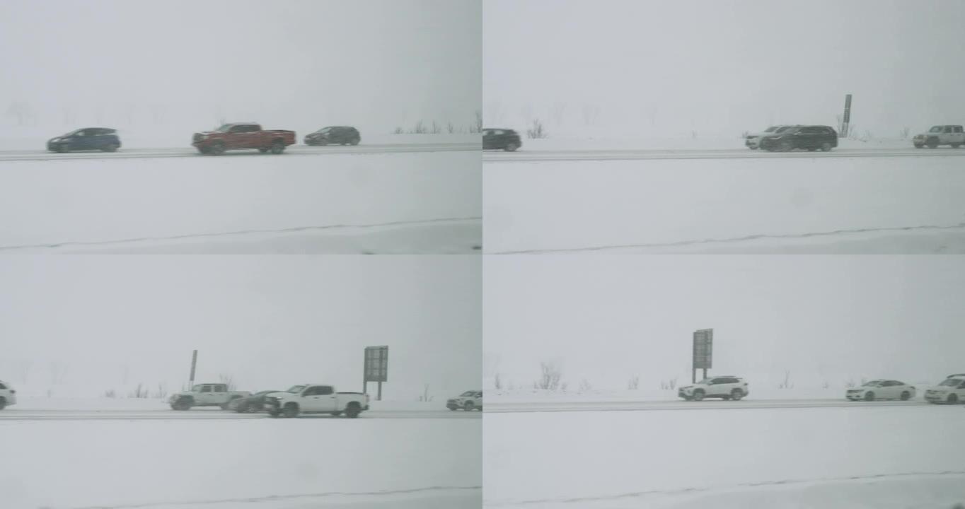 暴风雪，在高速公路上能见度差，道路湿滑，交通繁忙。冬天在暴风雪中行驶的汽车。