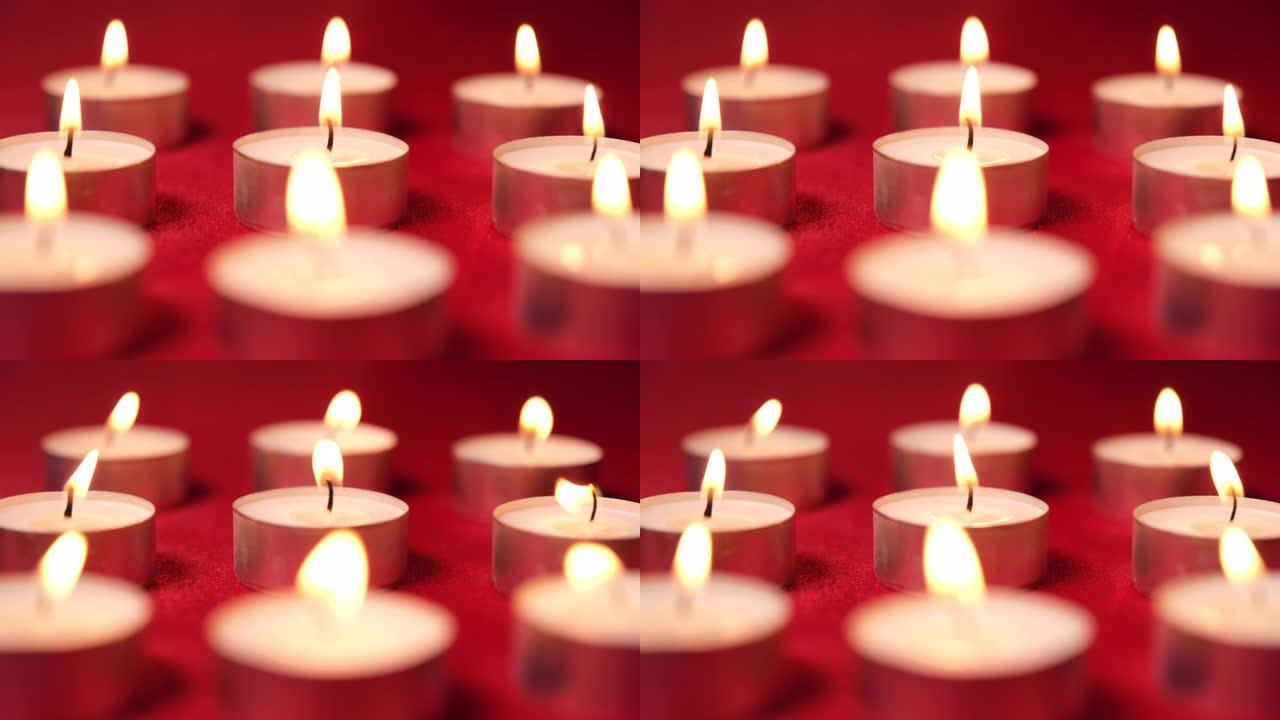红色背景上的圣诞节庆祝蜡烛。装饰用蜡烛灯，浪漫的情人节