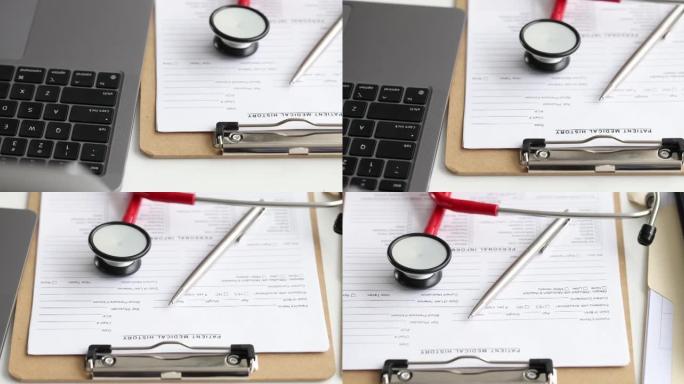 病人病历，桌上放着圆珠笔和听诊器，旁边放着笔记本电脑4k电影