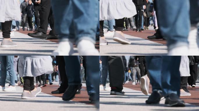人群的腿在街上行走，人们的脚特写，慢动作