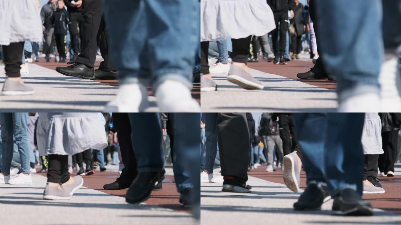 人群的腿在街上行走，人们的脚特写，慢动作