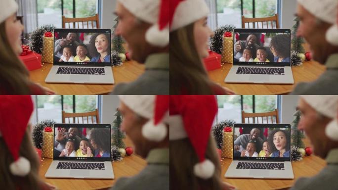 高加索人的祖父和祖父在圣诞节与家人在笔记本电脑上进行视频通话