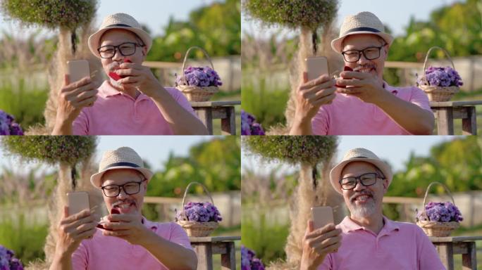 惊讶。在线视频通话，快乐的亚洲灰胡子男人戴眼镜向笔记本电脑上的女朋友求婚
