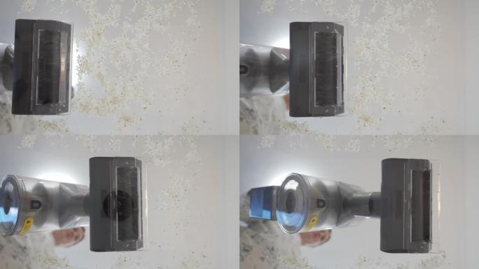 使用手持电池供电的真空吸尘器，从玻璃中吸取碎屑。