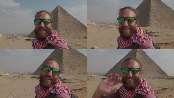 年轻人观光吉萨大金字塔会自拍。在埃及旅行的男性自拍很酷