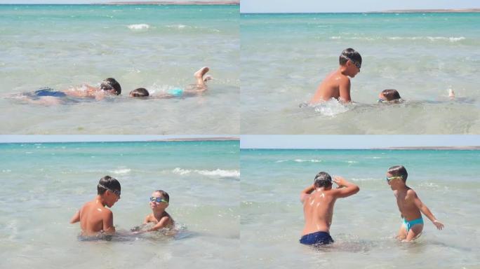 快乐，有趣的孩子，男孩在水下蔚蓝的大海中游泳，在海边玩耍。慢动作