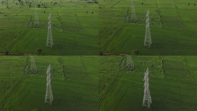 能源与自然农田田野间立起的高压电塔线特高