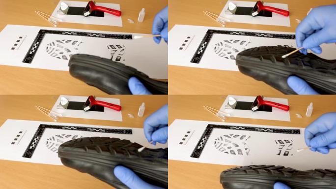 一名科学警察调查员CSI在实验室里用墨水采集鞋印样本