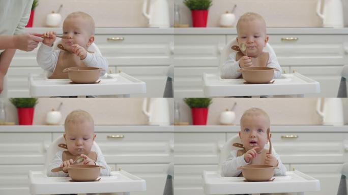 孩子吃粥，蹒跚学步的孩子用勺子学习吃饭，微笑的孩子用食物弄脏了脸。