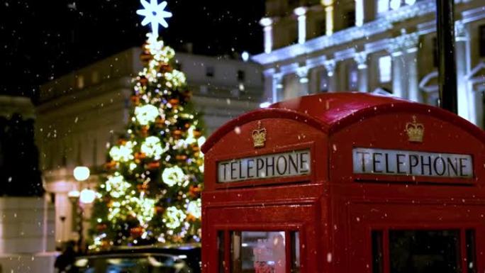 伦敦灯火通明的圣诞树前的经典红色电话亭