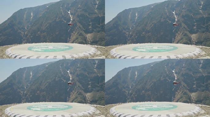 救援直升机在空中盘旋。直升机在山上的直升机场附近飞行