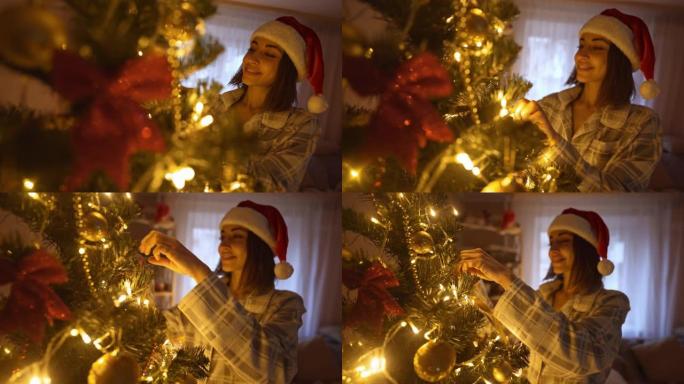 在家装饰圣诞树的迷人女人的慢动作。在家庭气氛中庆祝圣诞节和新年快乐