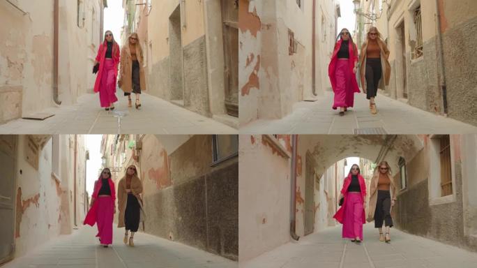 妇女在狭窄的威尼斯街上漫步在老房子之间