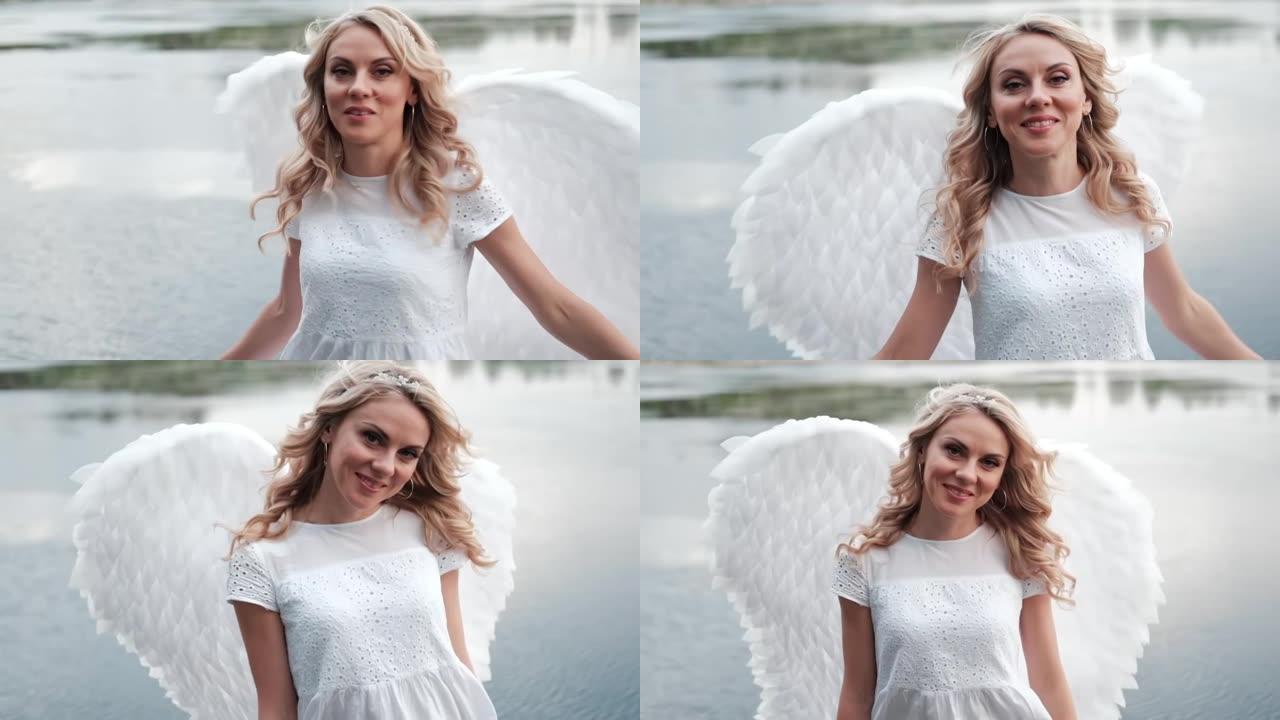 金发女人的肖像，白衣和白色的天使翅膀。好人。天上的神。天堂的天使。慢动作