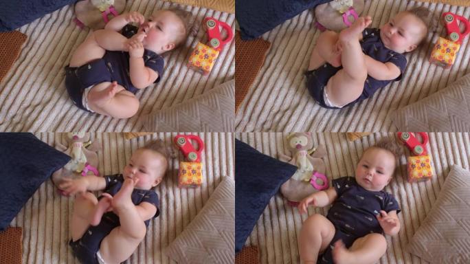 六个月大的婴儿把脚放进嘴里。良好的肌张力弯曲连枷肢。