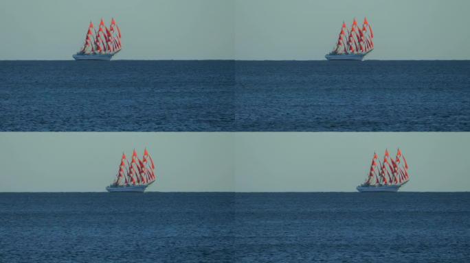 大风中红色帆上的帆船