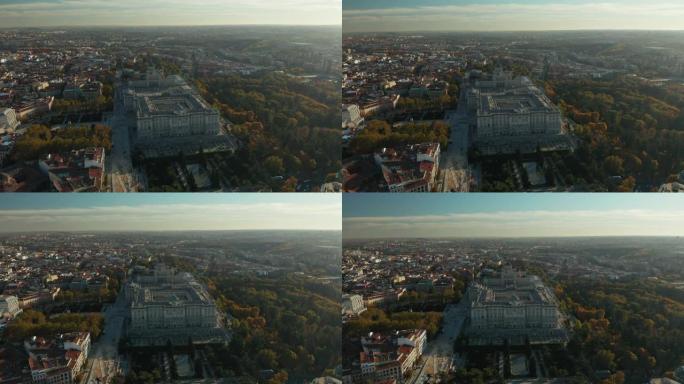 日落时城市的空中全景镜头。皇家宫殿建筑群和周围公园和花园上的雄伟建筑