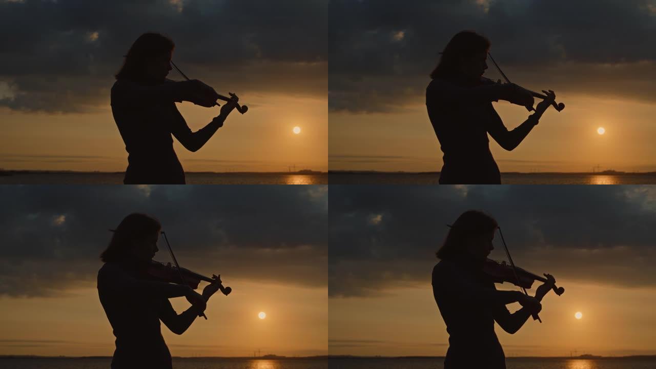 年轻女小提琴手的剪影