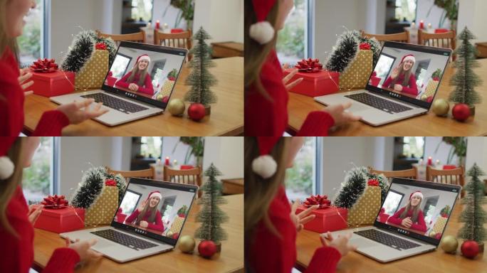 圣诞节时，白人妇女在笔记本电脑上与快乐的女性朋友进行视频通话