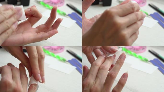 女孩在涂指甲油前用特殊液体给指甲脱脂，为指甲准备指甲