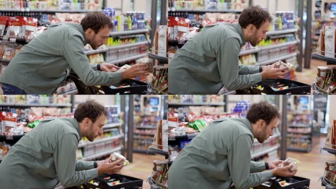 年轻人正在超市挑选饼干。他比较商标、价格、阅读标签和成分。特写