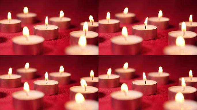 红色背景上的圣诞节庆祝蜡烛。装饰用蜡烛灯，浪漫的情人节