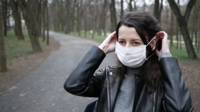 由于流感病毒，年轻女子白天在市中心的公园戴上口罩，并试图保护自己免受传染病的侵害。复制空间