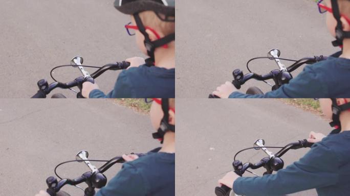 骑自行车的小男孩按喇叭