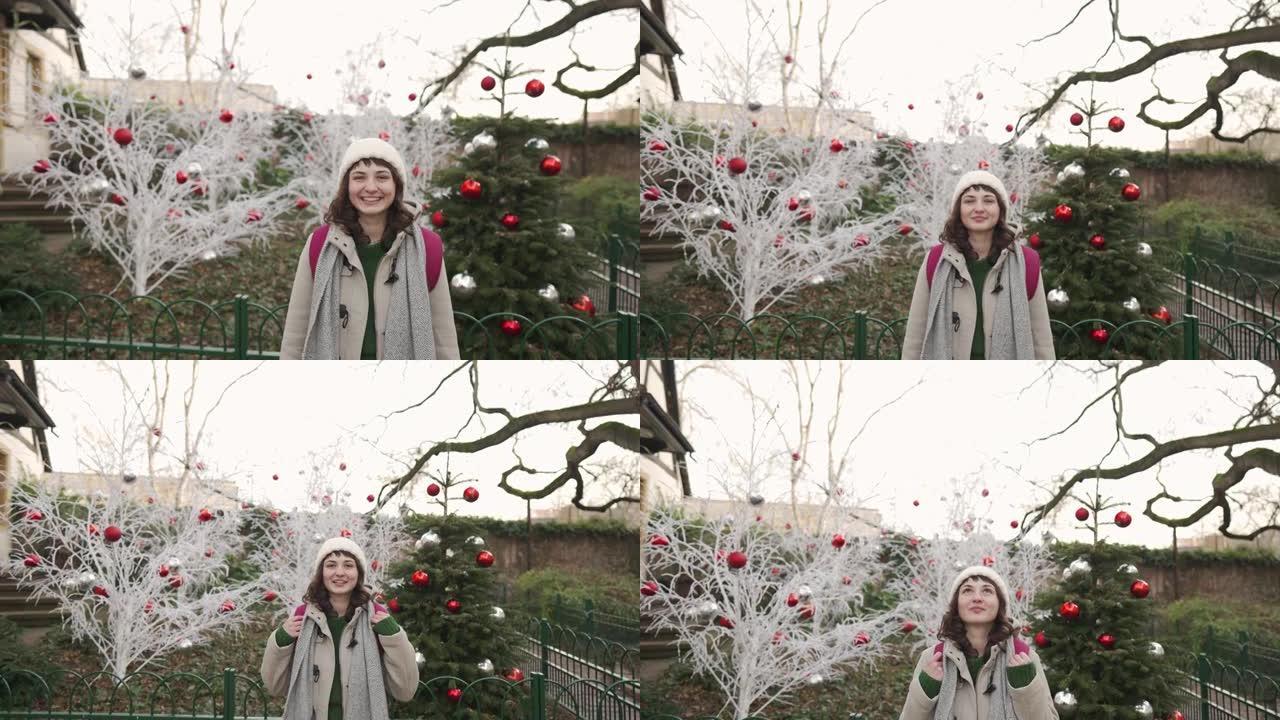 走在科尔马的女人在圣诞节期间用白树装饰