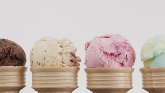 特写，放大，各种口味的冰淇淋舀在一个圆锥体上。