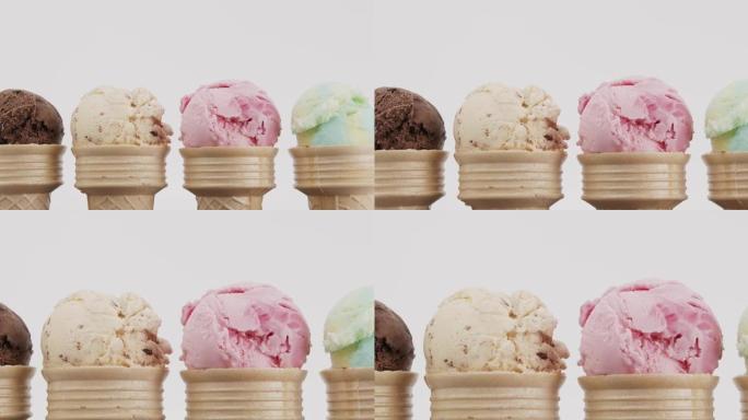 特写，放大，各种口味的冰淇淋舀在一个圆锥体上。
