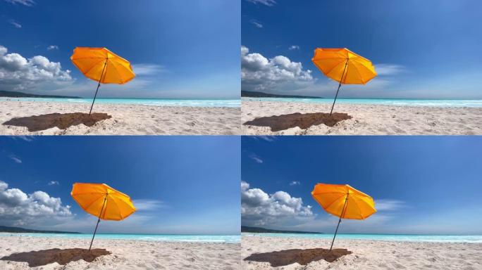 背景下阵风海洋下橙色伞空海滩的4k镜头