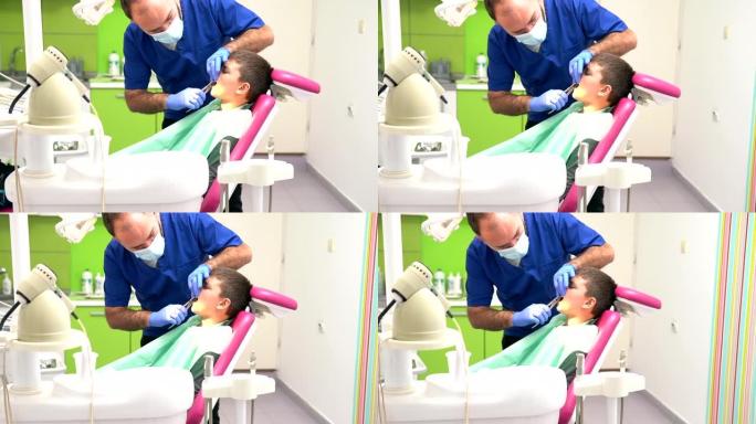 牙医用特殊的钳子拔男孩的牙齿