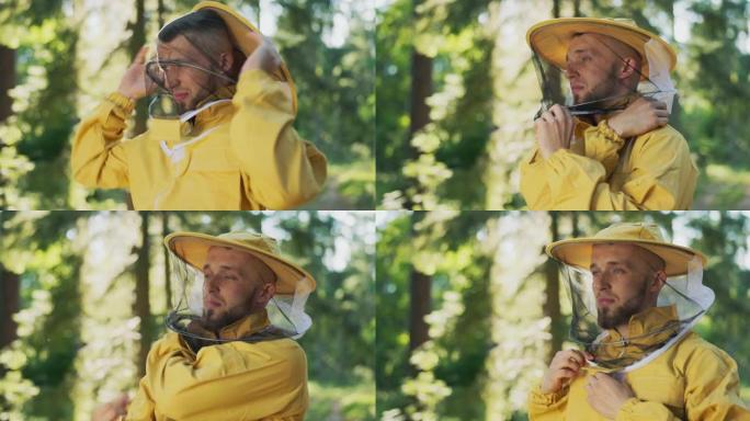 养蜂人准备在养蜂场的森林里用蜜蜂，蜂箱准备工作，他戴上了带有防护网的帽子，头上戴着蚊帐以保护他免受昆