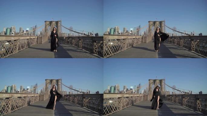 穿着黑色长裙的女人走过纽约布鲁克林大桥