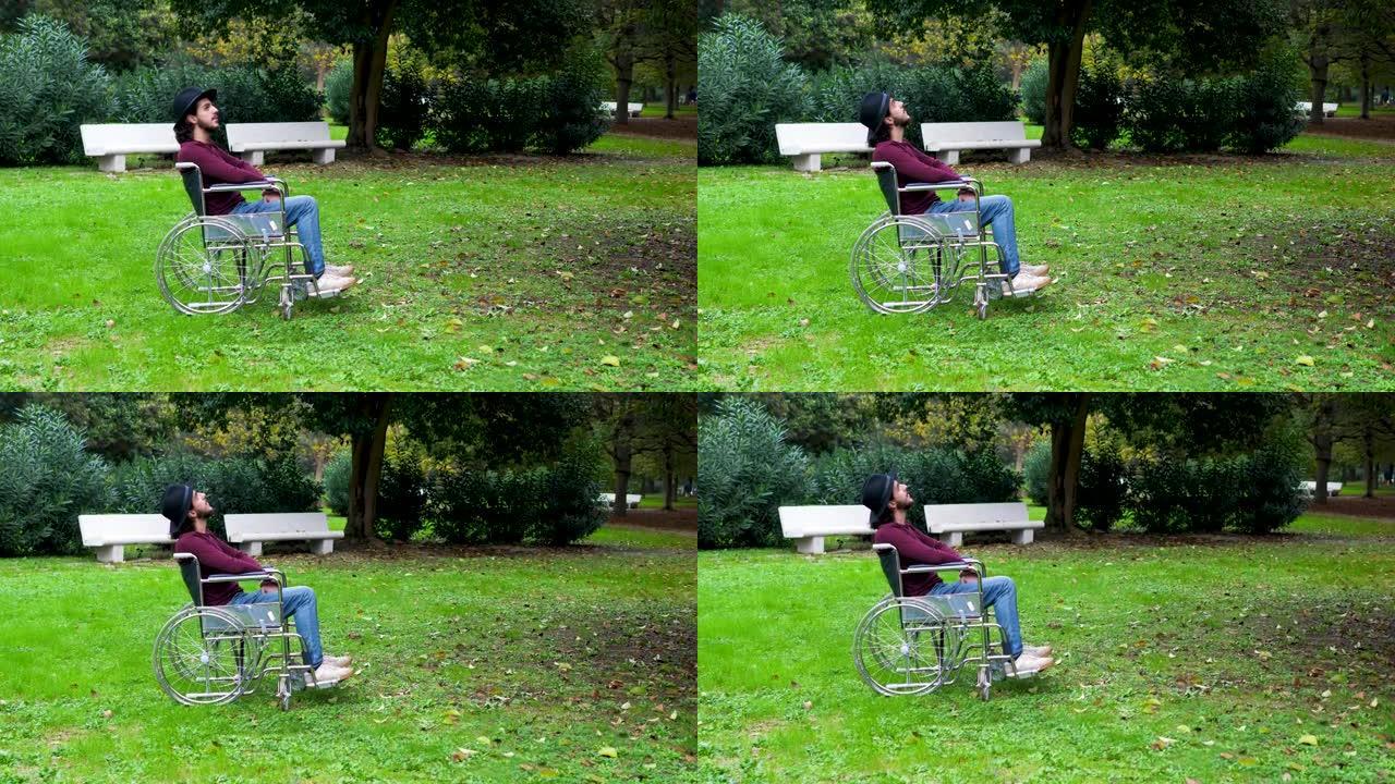残疾人-独自在公园里截瘫的人观察自然