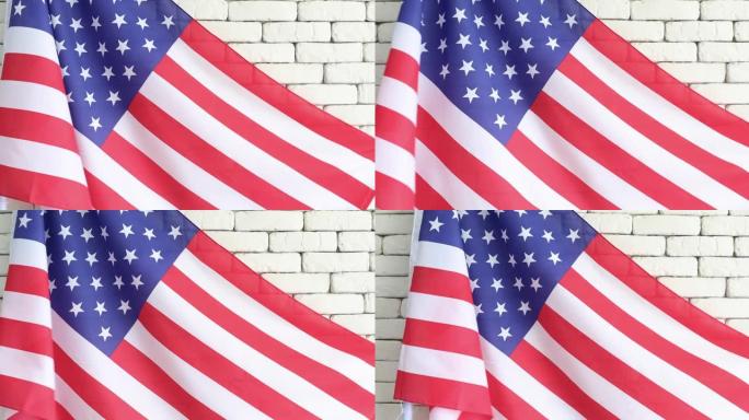 美国国旗，光滑的光，多风的白色砖墙背景