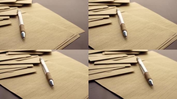 桌子上的信封、空纸和钢笔