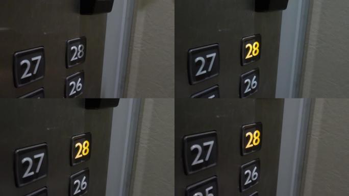 按下电梯按钮。手动按下升降按钮，直到办公楼或酒店的高层。现代住宅公寓的电梯按钮。电梯内部。使用消毒升