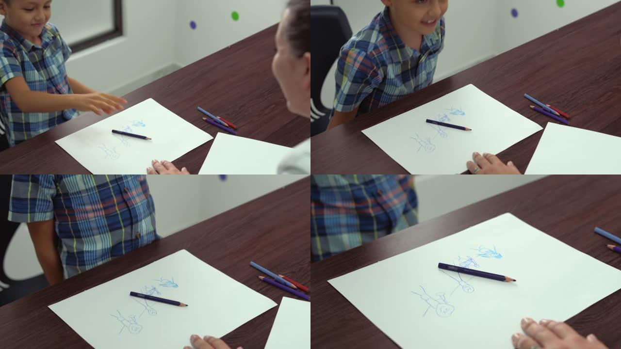 小男孩在游戏治疗会议上完成绘画