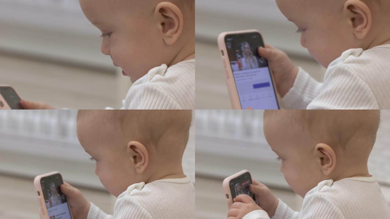 拿着智能手机的孩子在youtube频道上观看卡通，带iPhone的男婴坐在婴儿的摇椅上。
