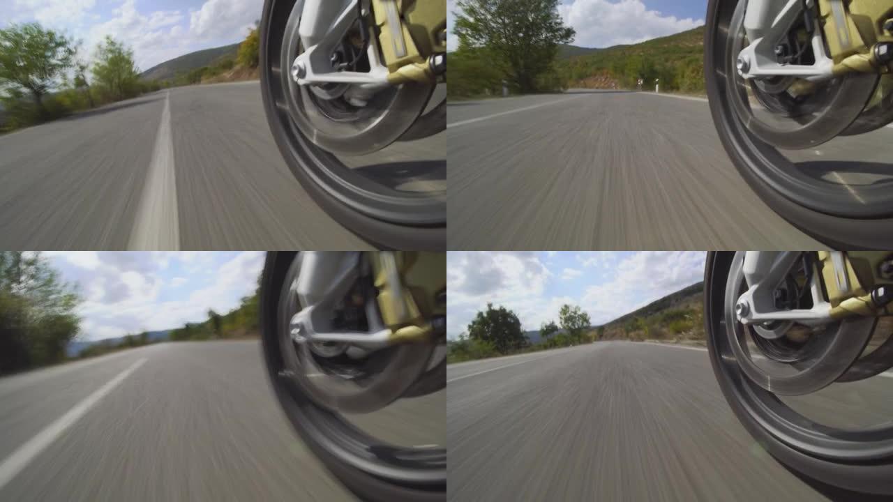 摩托车骑在自然界的道路上。在颠簸的沥青路面上关闭车轮。加速视频