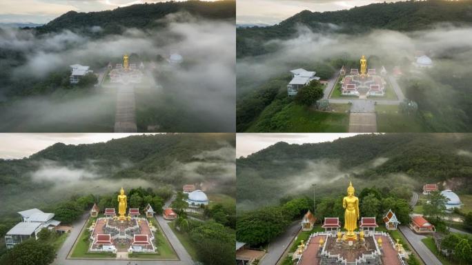 泰国宋卡府哈蒂区日出时山上大佛像周围移动雾的空中无人机超失效电影