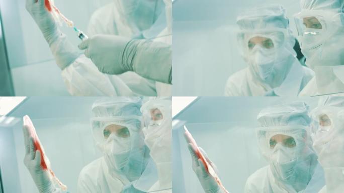 科学家们用注射器仔细检查血袋