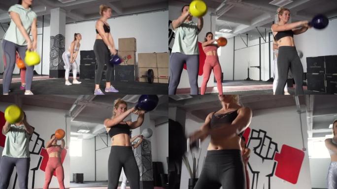 强壮活跃的高加索女性，在现代健身房用哑铃锻炼